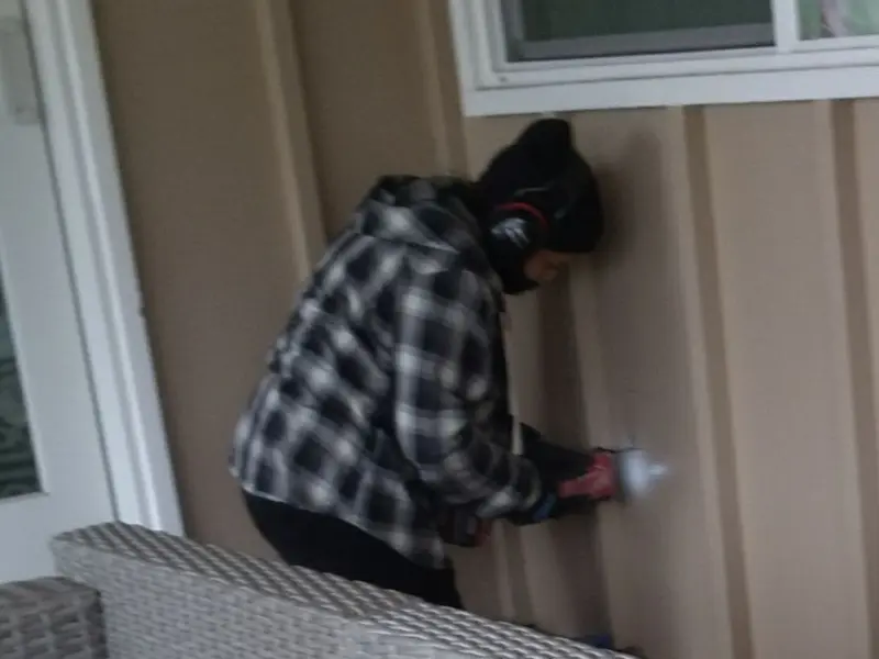 Professional electrician installing an exterior outlet in Kalispell